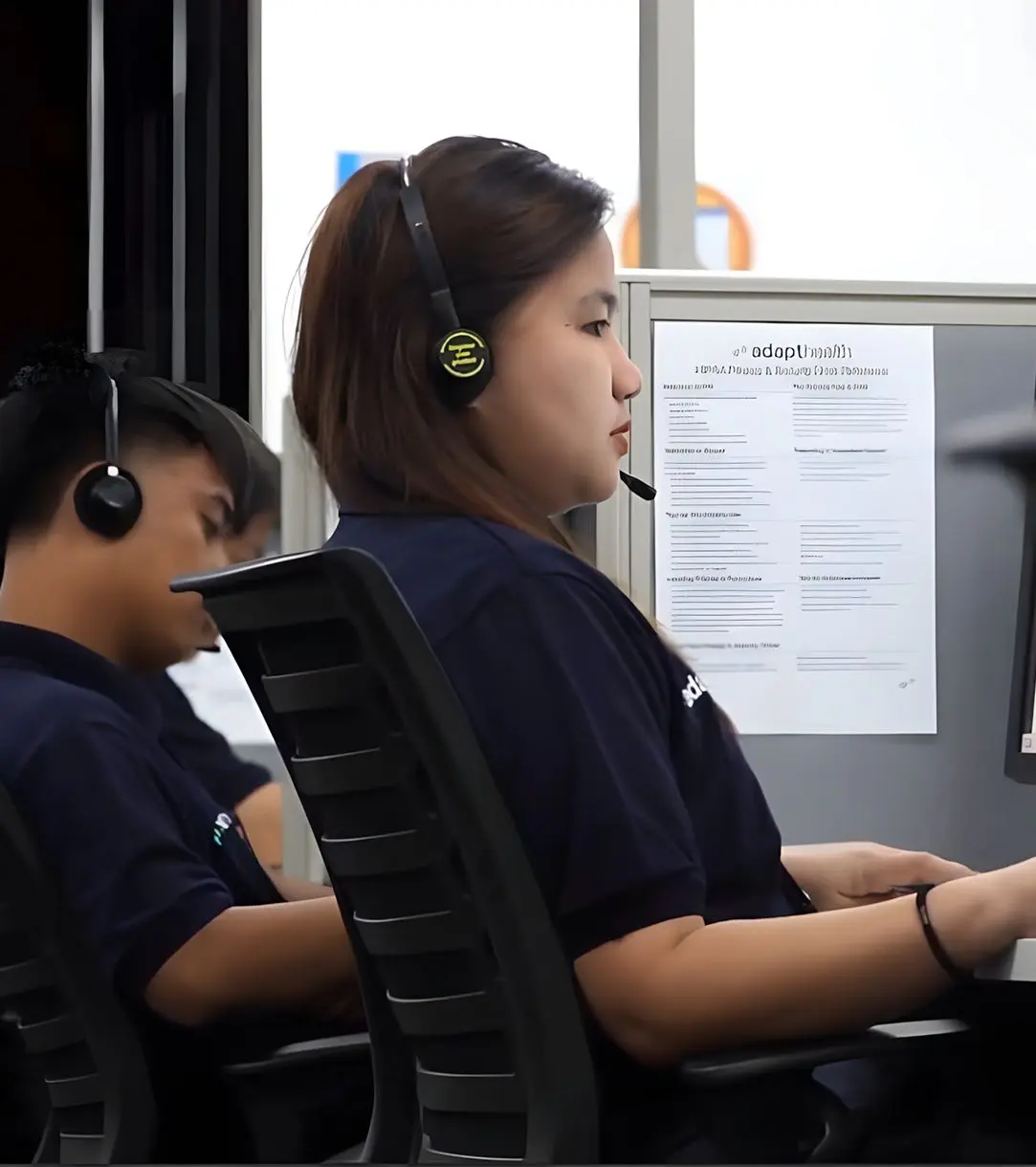 Healthscope team members wearing headsets at their workstations in the Philippines