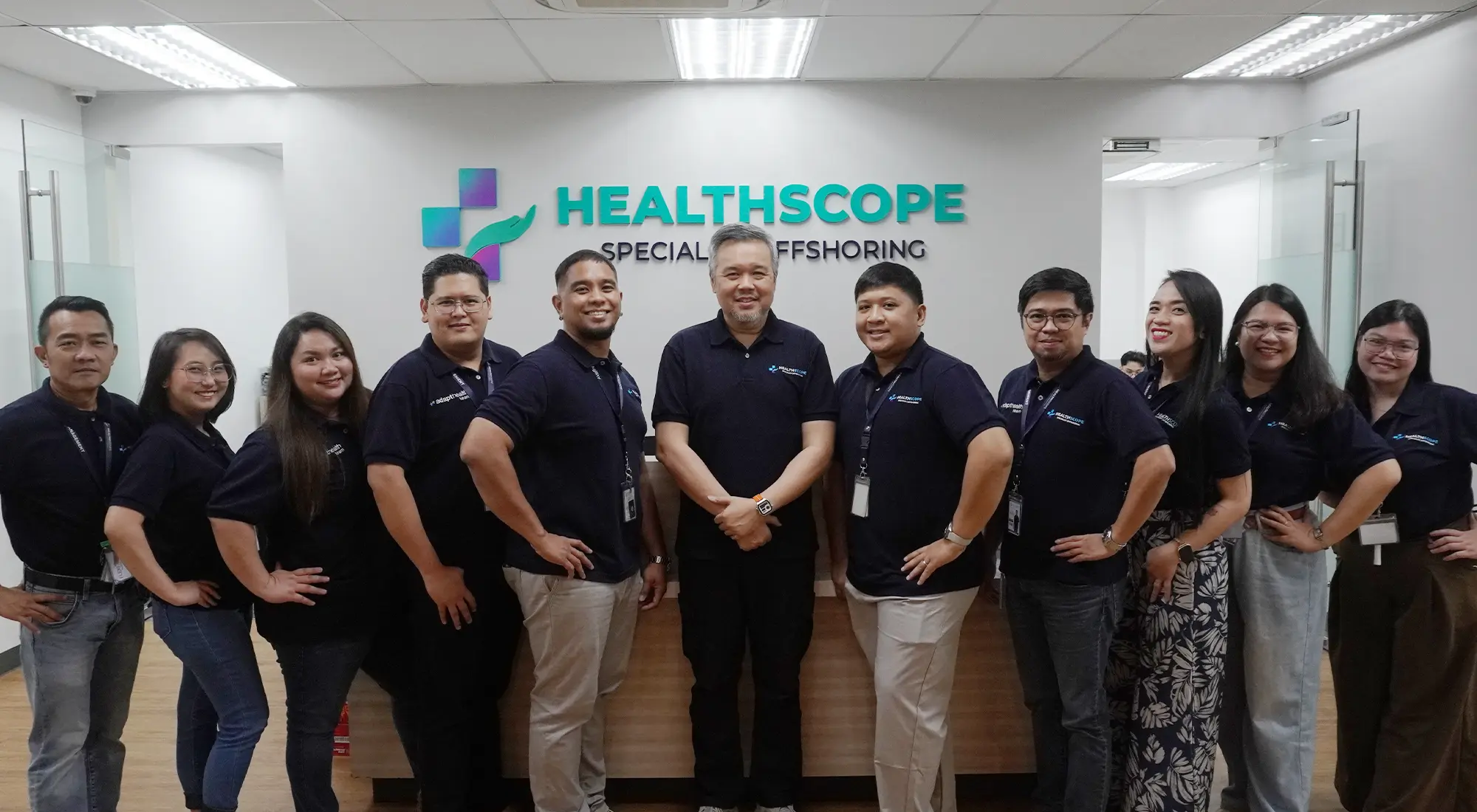Healthscope team members standing together in their office